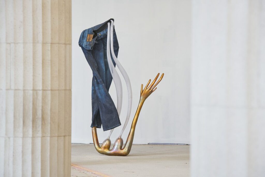 Camille Henrot End of Me 2021 Bronze, plastic tubing, jeans 230 x 62 x 120 cm / 90 1/2 x 24 3/8 x 47 1/4 in Exhibition view, The Stomach and the Port, Liverpool Biennial, 2021. © ADAGP Camille Henrot Courtesy the artist, kamel mennour (Paris/London) and König Galerie (Berlin/London/Seoul) Commissioned by the Liverpool Biennial 2021 Photo: Rob Battersby